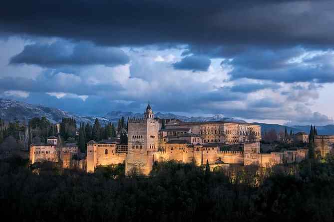 The Alhambra palace complex rising above Granada, Spain, with the Sierra Nevada in the background